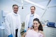 © wavebreak3 - Portrait of smiling dentists and female patient
