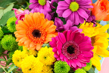 pink and orange transvaal daisy's in bunch of flowers.