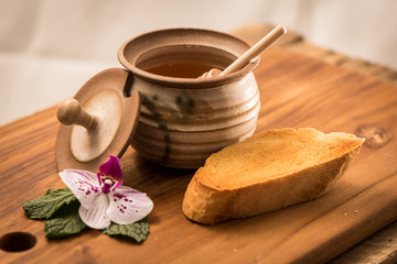 Wall Mural - Honey Dripping Onto Toast With Pot and Honey Stick