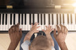 © tiagozr - Baby learning to play piano with father