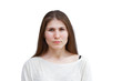 © mark_ka - Portrait of a young woman in a light jumper angrily looking directly at the camera isolated on white background. Demonstration of various emotions.