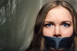 © drouk - A beautiful girl with a gag in her mouth as a symbol of censorship. Silence of issues of sexual discrimination.
