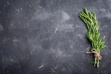 rosemary on concrete table. herbs and spices. cooking ingredients. top view and copy space for your 