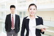 © zhu difeng - young asian businessman and businesswoman in modern office