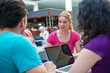 © FS-Stock - A group of teenagers sitting at the table in cafe, using laptop and drinking orange juice.