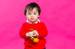 © leungchopan - Asian little boy holding Mandarin