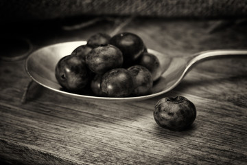 Wall Mural - Blueberries and spoon on a rustic background