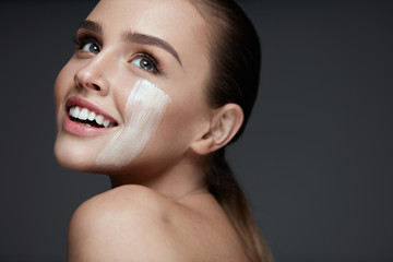 Wall Mural - attractive young woman with stripe of foundation on face