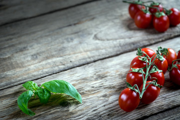 Fresh cherry tomatoes on rustic wooden table, Top view with copy space.