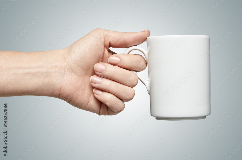 a woman hand holding a coffee mug Stock Photo | Adobe Stock
