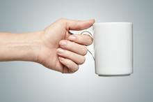 A Woman Hand Holding A Coffee Mug