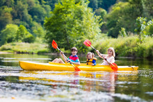 Family Enjoying Kayak Ride On A River