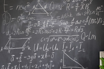 math formulas in white chalk on black board