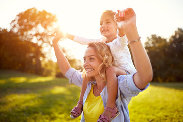 Mother and daughter together in park