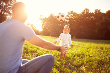 Wall Mural - Girl and her father plays with ball