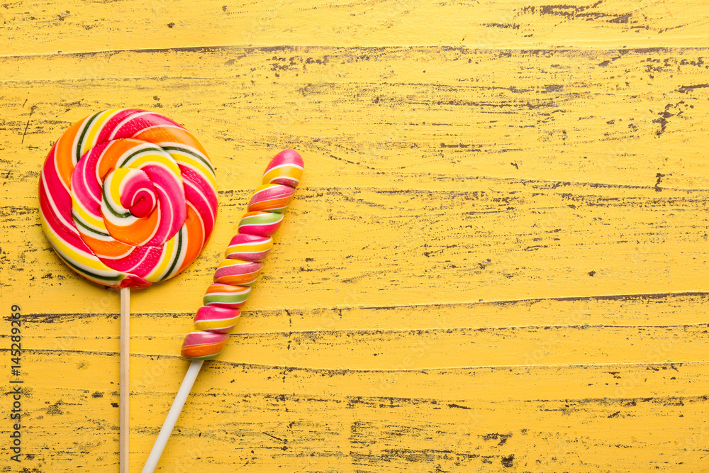 Tasty lollipops on shabby wooden background