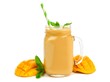 Mango coconut smoothie in a mason jar glass with mint and straw isolated on white