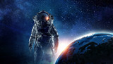 Fototapeta Kosmos - Astronaut in outer space. Mixed media . Mixed media