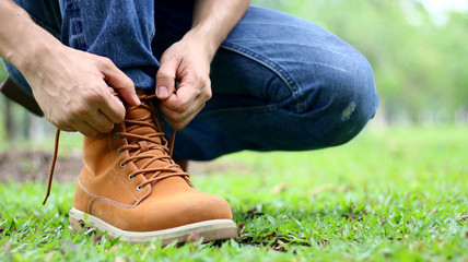 Men are tying a shoelace