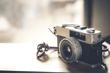 Vintage camera film on wood table. concept of remembrance and nostalgia. vintage color tone style.