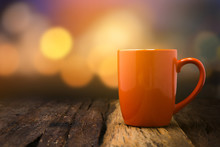 Orange Ceramic Empty Mug On Old Wooden Table Top With Copy Space And Bokeh Background