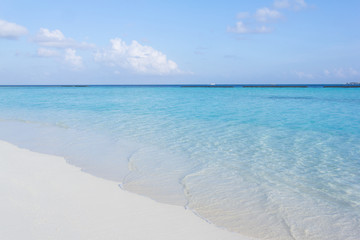 Tropical sand beach and blue sky with white clouds