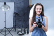 © Africa Studio - Young professional photographer with camera in studio