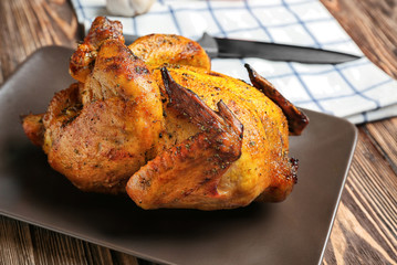 Sticker - Plate with roasted beer can chicken on wooden background