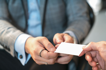 Closeup portrait of two successful business executive exchanging business card