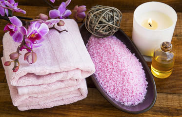 Spa still life with orchid flowers, towels,salt, scent candle and oil bottle