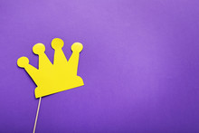 Yellow Paper Crown On Stick On Purple Background