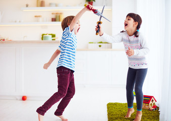 Wall Mural - kids playing active fight games at home kitchen