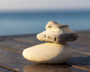 Two stones of irregular shape on the wooden board