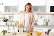 © Africa Studio - Beautiful young woman with lemonade in kitchen