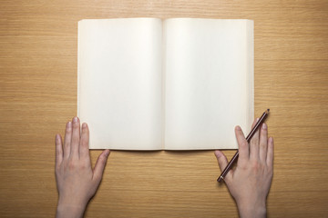 Wall Mural - woman hand hold a white note on the wood table(background)