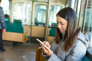 Canvas Print - Woman using cellphone in japanese train