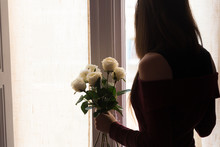 Beautiful female holding roses