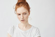 © Cookie Studio - Portrait of beautiful dissatisfied redhead girl with freckles.