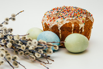 Easter composition on a white background - Easter cake, painted eggs, willow branches