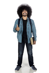 Wall Mural - College student showing thumb up with book