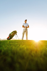 Sticker - Professional golfer standing on field at sunset