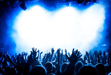 hands fans during a concert