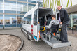 © corepics - Driver Assisting Passenger In Wheelchair To Board Taxi