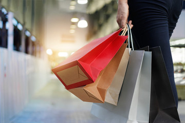 woman with shopping bags on shopping mall background.