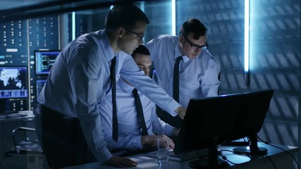 Aufkleber - Three Operation Controllers Solving Problem in System Control Room. Monitoring Room Has Multiple Displays with Visual Data Visible on Them.  Shot on RED EPIC-W 8K Helium Cinema Camera.