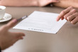 © fizkes - Close up view of contract, male hand pointing at some contractual terms, female offering to put a signature, basics of writing contract, negotiations for a deal, discussing document before signing