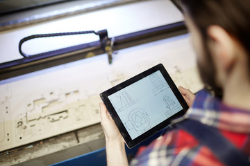 Modern engineer using sketch in touchpad during work