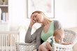 © Africa Studio - Depressed young woman with cute baby at home
