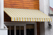 © Rattanachat - and white awning decor in front of the shop