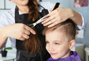 Wall Mural - Cute little boy in hairdressing salon